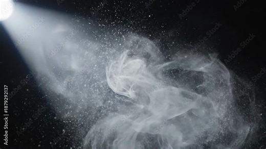 A captivating and dynamic beam of bright white light pierces through a dark mysterious background illuminating a swirling cloud of fine dust and smoke particles creating an ethereal and atmospheric s.
