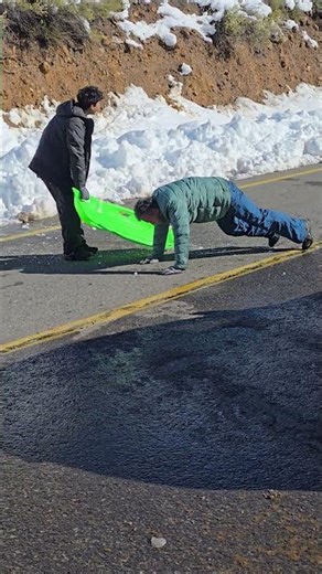 Sledder Slides From Snow To Road, Ends Up Face Down