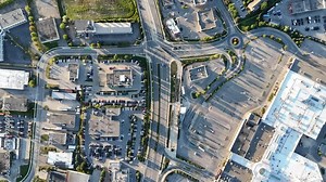 Top down aerial footage of the Highway 85 and the nearby urban buildings in Waterloo city, Canada