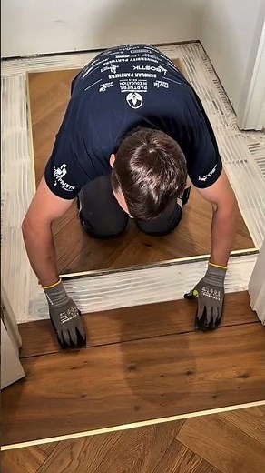 Installing dark brown wooden floor tiles for a professional and elegant home renovation project