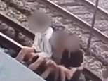 Man and woman are shocked by electric third rail while sitting on train tracks