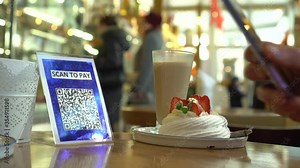 QR code cashless payment. Smartphone application for scan. The consumer scans the QR code displayed by the merchant with their phone to pay for their goods