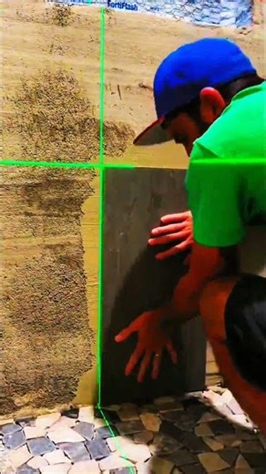 Tile pressed firm—laser guides rhythm of wall, cross, and panel aligns true with crafted precision