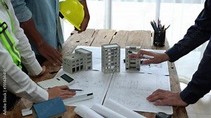 Projects work with partners and engineering tools to model and validate construction projects and work with on-site blueprints. Construction and structural concepts of engineer or architect meeting.