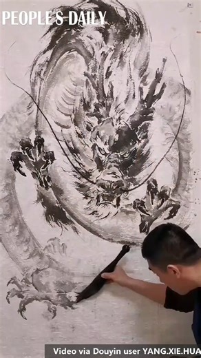 A mythological creature dragon comes to life under the brushstrokes of a Chinese ink painting artist. | People's Daily, China