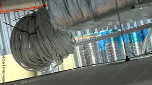 Electric cable reels suspended from the ceiling on an industrial site, High quality 4k footage
