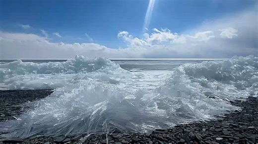 Mesmerizing crystalline ice sheets shatter as they push onto shore in China