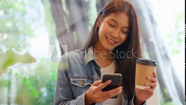 Young asian beautiful woman using smart phone in coffee shop cafe, typing write message on mobile, online shopping, transfer payment, internet banking