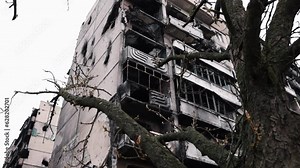 Fire aftermath, Ruined high-rise, Strike damage. Rocket's destructive strike brought down multi-storey building, and in its aftermath, house was left fire-ravaged.