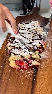 simple dessert everyone will love! girl makes yummy strawberries and cream strudel with pastry puff dough, cream cheese frosting, and strawberry pie mix. when she takes it out of the oven, she tops it with powdered sugar and chocolate syrup for a delightful treat! thanks for watching! this video was produced by Rick Lax, Network Media and Jacky P | Home Hacks & Easy Snacks