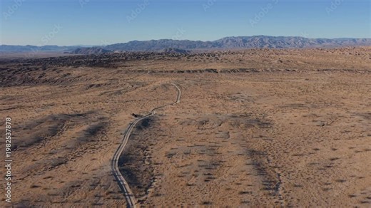 Explore aerial views of a teardrop camper trailer and SUV as they travel along Thimble Trail in Anza Borrego Desert State Park.