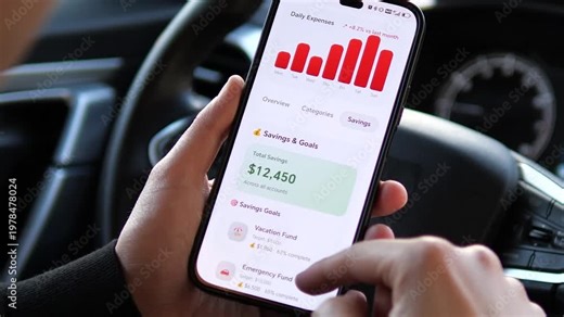Man tracking daily expenses and spending categories on a mobile banking app while in a car. Monitoring housing, food, and transport costs. Perfect for personal finance, budgeting, and fintech