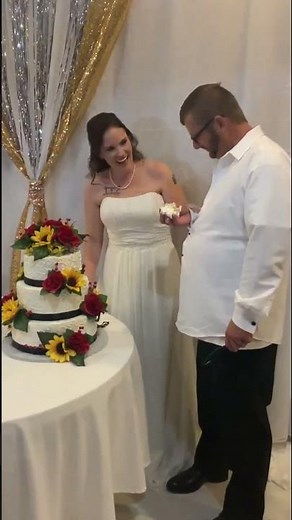 Groom surprises bride during cake-cutting at wedding in Chatsworth, Georgia, USA