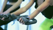 Group fitness riding a exercise bikes. Athletes girlfriend pedaling...
