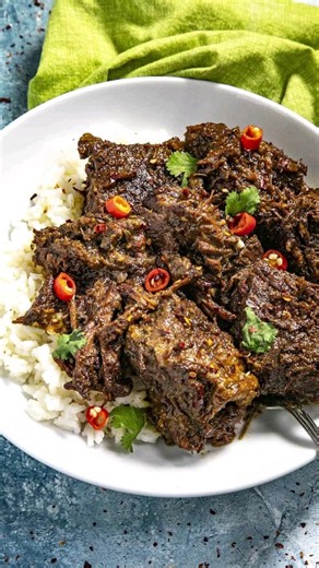 Beef rendang is a popular Indonesian dish with flavorful chunks of beef stewed low and slow in coconut milk and a wonderful blend of spices, so comforting. > > Comment “RECIPE" and I'll send this recipe straight to your DMs! 🥳 GET THE FULL RECIPE ⬇️ https://www.chilipeppermadness.com/recipes/beef-rendang/ Ingredients: FOR THE RENDANG PASTE 8 shallots chopped 5-6 Thai peppers chopped (or use spicy red chilies, or milder peppers for less heat) 8 cloves garlic chopped 2 tablespoons fresh chopped g