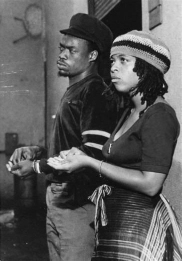 Michael Rose recorded extensively as a solo artist in Jamaica during the mid-1970s before joining Black Uhuru. In that period he worked with Niney the Observer and Lee “Scratch” Perry. Recording in those environments placed Rose within the heart of a movement shaped by Rastafarian themes, social commentary, and a heavier rhythmic emphasis than the rocksteady era that preceded it. His voice developed in dialogue with that sound: flexible, rhythmically precise, and immediately identifiable. “Runni