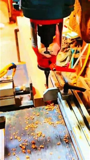 CNC router carves cylinder, shavings scatter below