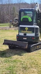 The Bobcat E26 making quick work tearing out overgrown junipers.