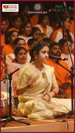 Sishyakulam | शिष्यकुलम् on Instagram: "At Sai Sishya Sahasra, our rendition of Partheeshwara Sathya Saishwara in Charukesi found its heart in the voice of one of the youngest members of our ensemble and a rising star of devotional music, Kum. Sooryagayathri. She had just completed a performance in Coimbatore and arrived in Chennai that very afternoon. Without being able to attend a single rehearsal, she walked onto the stage with the confidence and composure of someone who had lived with the pi