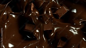 Super Slow Motion of Falling Chocolate Pieces into Melted Chocolate. Filmed with High Speed Cinema Camera, 1000fps.