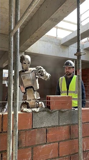 A humanoid robot laying bricks on a live construction site.