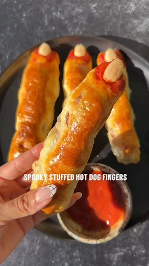 SPOOKY STUFFED HOT DOG FINGERS If you are looking for a savory spooky meal idea for your Halloween festivities. Make these easy and delicious stuffed hot dog spooky fingers! Sure to be a crowd pleaser! Make sure to save this one and follow along for more spooky eats! What you’ll need: 5 hot dogs of choice, I used uncured grass fed beef ones for mine 1 package Organic crescent roll dough 1 pasture raised organic egg Marcona almonds Organic Ketchup Organic string cheese Instructions: 1. Make a sli