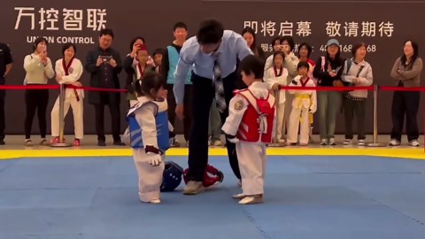 Funny children's taekwondo match as battling kids fail to kick one another