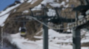 The mechanism of the cable car to the cable car for the transport of passengers in blur or defocus,. Close-up rollers and pulleys running on the cable car.