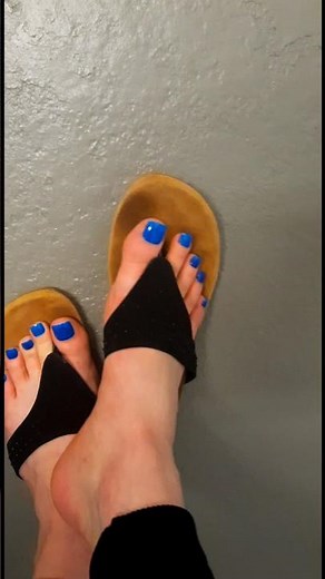 Blue toes bare feet and well worn flip flops