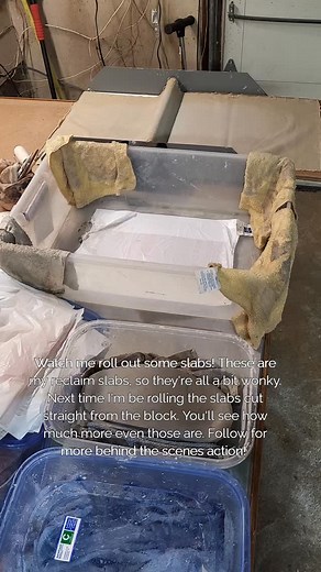 Watch me roll out some slabs! These are my reclaim slabs, so they're all a bit wonky. Next time I'm be rolling the slabs cut straight from the block. You'll see how much more even those are. I roll out a bunch at a time and layer them between plastic to keep them soft. Then when I sit down to work I can do so more efficiently. Follow for more behind the scenes action! #newphasepottery #handbuiltpottery #behindthescenes #slabroller #handmade #reclaim #recycle | New Phase Pottery