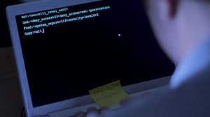 clip-5033090-back-view-male-computer-hacker-typing-code