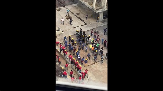 Builders do group stretching sessions before day on construction site