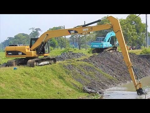 Long Arm Excavator Digging The River Canal CAT 320D L Komatsu PC200