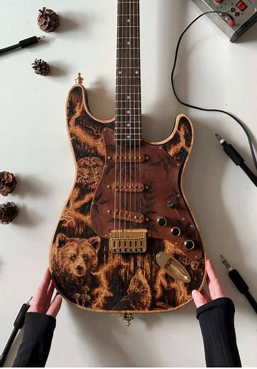 A closer look at my original pyrography work titled ‘Electric’. This was hands down the most challenging design concept I’ve ever burned! It was a real treat to try and master composition and flow of the artwork around the shape of the guitar body and headstock. Burning the curved surface along the edges was also a new experience for me. Curved surfaces are less forgiving to pyrography techniques as it required an extremely steady hand and even slower pace. Guitar custom built by Trailblazer Gui