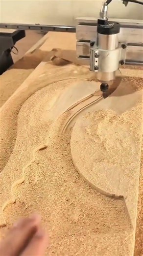 carving a complex pattern into a wood board using an automated cnc router machine