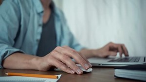 clip-30681229-male-hands-using-wireless-mouse-making-note