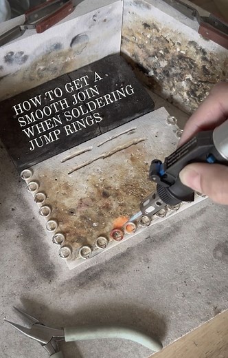 Metalsmith Society on Instagram: "TL;DR: Tired of flat spots when soldering jump rings? @willowandtwigg suggests positioning the join just over the edge of your soldering block instead of flat on it—this reduces cleanup time and gives smoother results. She uses paste solder for its clean, stay-put convenience (just don’t hit it directly with your flame). Genius time-saver, especially if you’re soldering a ton! 🔥💍 Here is a tip for positioning jump rings for soldering from @willowandtwigg : “I 