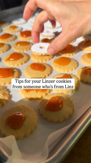 Astrid Lamarche on Instagram: "The real ones .. use a 1-2-3 dough. ♥️ original Linzer cookies don’t have any nuts in the dough ♥️ punch 3 little holes or one central hole for the tops. Easier to do this when on the baking sheet ♥️ let cool slightly then dust the tops with powdered sugar ♥️use the best apricot jam and be generous - add a tiny bit of @stroh_austria for that extra flavor ♥️ wiggle the tops on so the jam can come up and fill the hole(s) ♥️ use a toothpick to hide sugar spills These