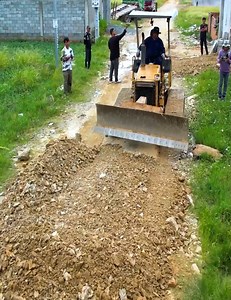 Dump truck unloads stones as driver manages flood | Green Goals