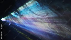 Film projector with flashing lights in colorful smoke. Searchlight provides bright colored beam. demonstrates movies with colour rays. Rainbow light, home theater, transmitting picture on screen