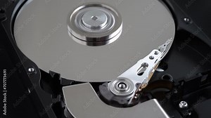 Hard disk drive inside with rotating platter and riding arm