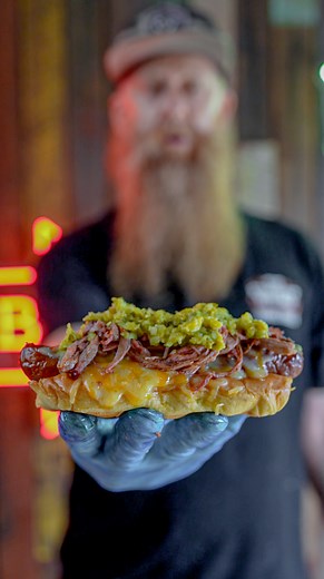 Smoked Kransky hot dog with pulled pork and pickle relish. Thanks to Graeme Stockdale from The Stockpot Kitchen - Smokehouse BBQ and Fried Chicken for this epic recipe that hits all the right flavor notes. Take your hot dog game to the next level and give it a go. #hotdog #barbecue #recipe | Meatstock Sydney