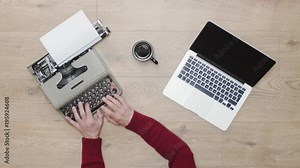 Old vs New technology. Typing on both modern computer laptop and old obsolete typewriter, contrast between modern and retro obsolete. Old and new era. 4K video, green screen
