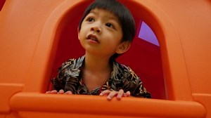 asian cute boy happy playful playing in house playground