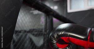 Close up boxing gloves hitting punching bag, training in boxing gym. Extreme combat sports, aggressive boxer hitting punching bag in gloves, slow motion - exercising and preparing for a fight Stock Video