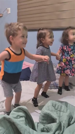 Playful Dance Moments with Kids in a Cozy Bedroom