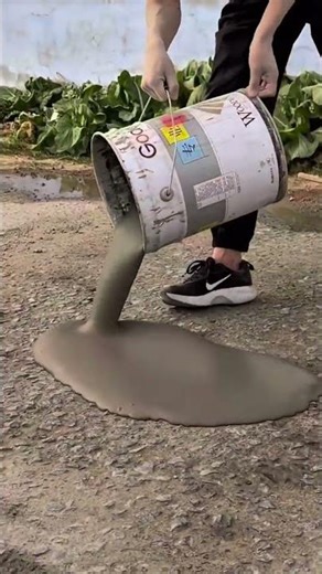 Mixing cement into a smooth liquid to create a solid, even pathway for the new road #construction