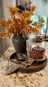 🍂Timeless & Tasteful Fall Centerpiece 🔗Comment, SHOP INFO PLEASE, and I’ll send you the affiliate links to shop OR you can always shop this reel with the LTK link in my bio or on my @shop.ltk | https://liketk.it/5lj5F This fall tray styling blends cozy charm with functional elegance. A large vintage ceramic vase is filled with golden autumn branches, paired with a wood-lidded glass pumpkin candy jar, a seasonal cookbook, and dainty fall bowls resting on a floral kitchen towel. The rich texture