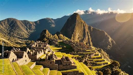 Scenic aerial view of the historic Machu Picchu ruins in the Peruvian Andes mountains under a bright sunny sky