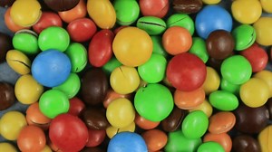 Download Candy sweets background. Assorted colorful chocolate candies. Colorful delicious sweets turning top view. for free